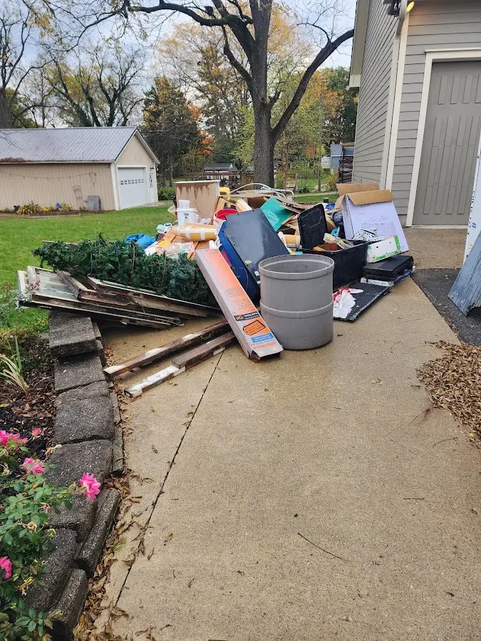 Dumpster being loaded with debris for Estate Cleanout Dumpster Rental in Glendale Heights